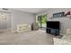 Spacious living room with neutral walls and a sliding door that floods the room with natural light at 3241 Fox Chase N Cir # 106, Palm Harbor, FL 34683