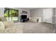 Cozy living room features plush carpeting, neutral paint, and sliding glass doors at 3241 Fox Chase N Cir # 106, Palm Harbor, FL 34683