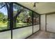 View from screened porch featuring a well-kept yard and foliage at 3241 Fox Chase N Cir # 106, Palm Harbor, FL 34683
