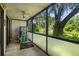 Spacious screened porch showcasing the backyard and lush landscaping at 3241 Fox Chase N Cir # 106, Palm Harbor, FL 34683