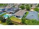 Aerial view of the backyard with a screened lanai and fencing, plus a view of the neighborhood at 32648 Coldwater Creek Loop, Wesley Chapel, FL 33545