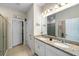 Bathroom featuring double sink vanity with granite countertops and a tiled floor at 32648 Coldwater Creek Loop, Wesley Chapel, FL 33545