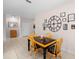 Cozy dining area with a unique black and wood table, comfortable seating, and decorative wall art at 32648 Coldwater Creek Loop, Wesley Chapel, FL 33545