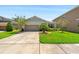 Charming single-story home with a well-manicured lawn and a two car garage at 32648 Coldwater Creek Loop, Wesley Chapel, FL 33545