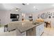 Modern kitchen with granite countertops, stainless steel appliances, and a breakfast bar overlooking the living area at 32648 Coldwater Creek Loop, Wesley Chapel, FL 33545