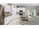 Well-lit kitchen featuring granite counters, a stainless steel refrigerator, and ample cabinet space at 32648 Coldwater Creek Loop, Wesley Chapel, FL 33545