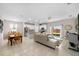 Open floor plan showing the dining area, kitchen, and living room, creating a welcoming and connected space at 32648 Coldwater Creek Loop, Wesley Chapel, FL 33545