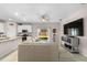 Bright living room with sliding glass doors to the patio, flowing into the kitchen area at 32648 Coldwater Creek Loop, Wesley Chapel, FL 33545