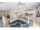 Open-concept living room featuring neutral tones, recessed lighting, and easy access to the kitchen and dining area at 32648 Coldwater Creek Loop, Wesley Chapel, FL 33545