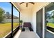 Relaxing screened patio with a ceiling fan, potted plant, and outdoor seating at 32648 Coldwater Creek Loop, Wesley Chapel, FL 33545