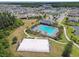 Community aerial view featuring a pool, basketball court, park, and residential homes at 32791 Natural Bridge Rd, Wesley Chapel, FL 33543