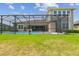 Well-maintained backyard with a screened-in pool and patio offering a serene outdoor living space at 32791 Natural Bridge Rd, Wesley Chapel, FL 33543