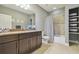Bathroom featuring granite countertops, shower with tub, and neutral tile at 32791 Natural Bridge Rd, Wesley Chapel, FL 33543