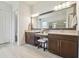 Bright bathroom featuring a dual vanity with a large mirror, granite counters, and walk-in shower at 32791 Natural Bridge Rd, Wesley Chapel, FL 33543