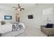 Comfortable primary bedroom with a chair, tv and windows at 32791 Natural Bridge Rd, Wesley Chapel, FL 33543