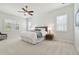 Bright bedroom with plush carpeting, a large bed, and plantation shutters on the windows at 32791 Natural Bridge Rd, Wesley Chapel, FL 33543