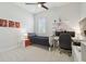 Cozy bedroom featuring neutral walls, a comfortable bed, and dedicated desk space, ideal for relaxation and study at 32791 Natural Bridge Rd, Wesley Chapel, FL 33543