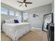 Comfortable bedroom with three windows, neutral walls, carpet flooring, and ceiling fan at 32791 Natural Bridge Rd, Wesley Chapel, FL 33543