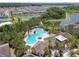 Aerial view of the resort-style community pool with ample seating, lush landscaping, and inviting lounging areas at 32791 Natural Bridge Rd, Wesley Chapel, FL 33543