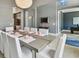 Formal dining room with seating for ten, chandelier, and grey paint at 32791 Natural Bridge Rd, Wesley Chapel, FL 33543
