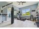 Light and airy exercise room featuring a treadmill, weights, and punching bag at 32791 Natural Bridge Rd, Wesley Chapel, FL 33543