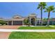 Charming home featuring a three-car garage, manicured lawn, and elegant landscaping at 32791 Natural Bridge Rd, Wesley Chapel, FL 33543