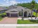 Stately two-story home with a three-car garage, well-manicured landscaping, and welcoming entrance at 32791 Natural Bridge Rd, Wesley Chapel, FL 33543