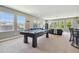 Spacious game room features a pool table, comfortable seating area, and plenty of natural light at 32791 Natural Bridge Rd, Wesley Chapel, FL 33543