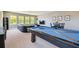Spacious game room with a pool table, entertainment area, and comfortable seating at 32791 Natural Bridge Rd, Wesley Chapel, FL 33543