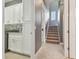 Hallway featuring laundry area and stairway with large grey tile flooring at 32791 Natural Bridge Rd, Wesley Chapel, FL 33543