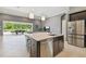 Modern kitchen with large island, stainless steel appliances, bar stool seating and an open floorplan at 32791 Natural Bridge Rd, Wesley Chapel, FL 33543