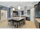 Beautiful kitchen island with seating, modern stainless appliances, and stylish backsplash at 32791 Natural Bridge Rd, Wesley Chapel, FL 33543