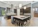 Modern kitchen featuring a large island with seating, stainless steel appliances, and stylish backsplash at 32791 Natural Bridge Rd, Wesley Chapel, FL 33543