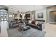 Open-concept living room with tile flooring, modern decor and dark leather couches at 32791 Natural Bridge Rd, Wesley Chapel, FL 33543
