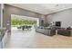 Open floor plan with modern gray walls flows to the screened lanai at 32791 Natural Bridge Rd, Wesley Chapel, FL 33543