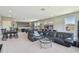 Expansive living room featuring a pool table, seating area, and ample natural light, perfect for entertaining and relaxation at 32791 Natural Bridge Rd, Wesley Chapel, FL 33543