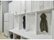 A well-organized mudroom featuring white cabinetry, cubbies, hooks, and convenient storage at 32791 Natural Bridge Rd, Wesley Chapel, FL 33543