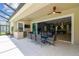 Covered patio with outdoor dining area and built-in grill, perfect for entertaining at 32791 Natural Bridge Rd, Wesley Chapel, FL 33543
