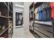 Spacious walk-in closet with custom shelving and organization systems for clothes and shoes at 32791 Natural Bridge Rd, Wesley Chapel, FL 33543