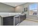 Elegant wet bar area with granite countertops, cabinetry, sink, and a built-in beverage cooler at 32791 Natural Bridge Rd, Wesley Chapel, FL 33543