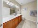 Bathroom with a large vanity, double sinks, and ceramic tile flooring at 334 Mystic Falls Dr, Apollo Beach, FL 33572