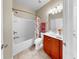 Full bathroom with tile floors, shower-tub combo, single sink vanity, and ample lighting at 334 Mystic Falls Dr, Apollo Beach, FL 33572