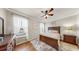 Warm bedroom with hardwood floors, natural lighting, and classic wooden furniture at 334 Mystic Falls Dr, Apollo Beach, FL 33572