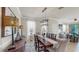 Stylish dining area features a wooden table, decorative lamps, and view into the living room at 334 Mystic Falls Dr, Apollo Beach, FL 33572
