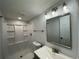 Updated bathroom featuring a shower, new vanity, lighting, and a framed mirror at 34141 Tree Lake Dr, Wesley Chapel, FL 33543