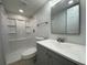 Bathroom featuring a large framed mirror, new vanity, lighting, and shower at 34141 Tree Lake Dr, Wesley Chapel, FL 33543
