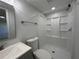 Well-lit bathroom with a shower and vanity, complemented by modern fixtures at 34141 Tree Lake Dr, Wesley Chapel, FL 33543