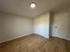 Comfortable bedroom with a closet, wood-look laminate flooring, and neutral paint at 34141 Tree Lake Dr, Wesley Chapel, FL 33543