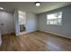 Bright bedroom featuring laminate wood flooring, closet, en-suite bathroom and natural light at 34141 Tree Lake Dr, Wesley Chapel, FL 33543