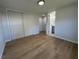 Bright bedroom featuring laminate wood flooring, closet, and access to the en-suite bathroom at 34141 Tree Lake Dr, Wesley Chapel, FL 33543